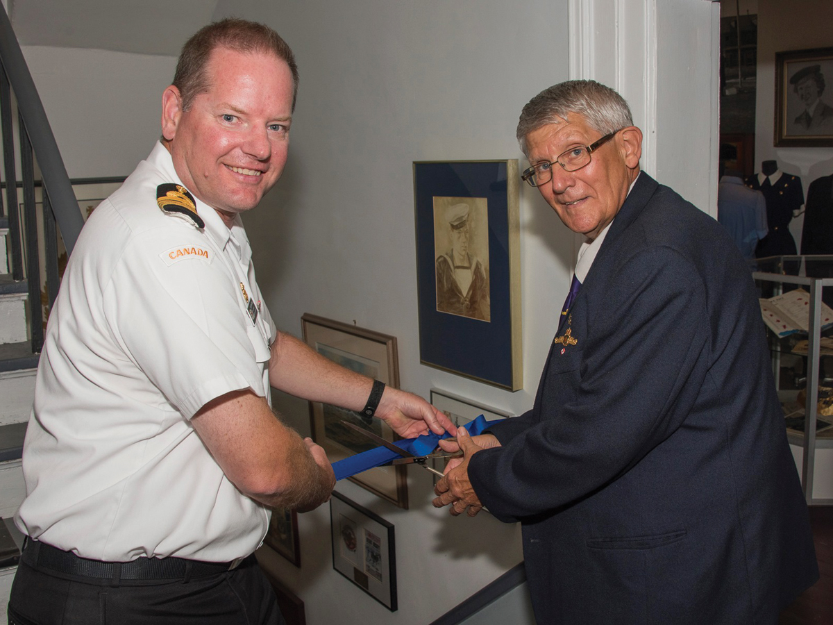Capt(N) David Mazur, CFB Halifax Base Commander, and CPO2 (Retired) Brian Lapierre, a former submariner, cut the ribbon to officially open the Naval Museum of Halifax’s newest exhibit. Photo by Cpl Thompson, Formation Imaging Services