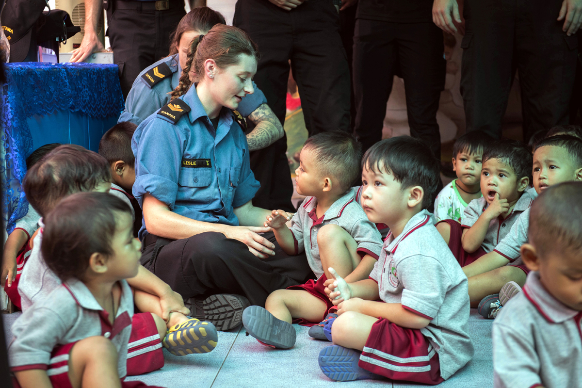 Master Seaman Veronica Leslie interacts with a preschool class during a trip to the Father Ray Foundation. Photo by Leading Seaman Victoria Ioganov, MARPAC Imaging Services