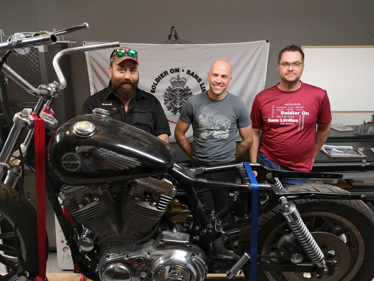 Yanick Létourneau, Christian Jalbert and Érick Cloutier will work as a team to transform a motorbike as a benefit to the Soldier On program. Photo by Édouard Dufour, Adsum Newspaper
