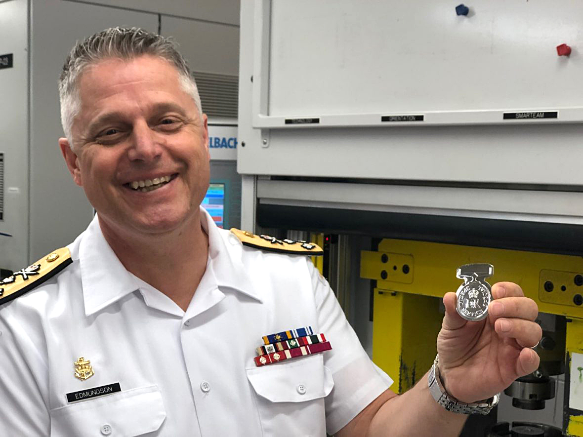 Vice-Admiral Haydn Edmundson, Acting Commander, Military Personnel Command, with the Special Service Medal he struck during a recent tour of the Royal Canadian Mint.