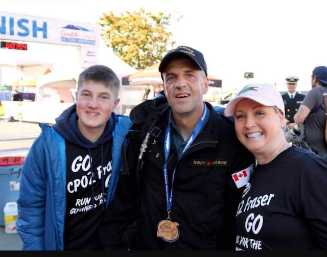 CPO2 Chris Fraser enjoys a moment with his son Andriy and wife Natalia after completing the Goodlife Fitness Marathon in full firefighter gear. Photo credit: MFRC