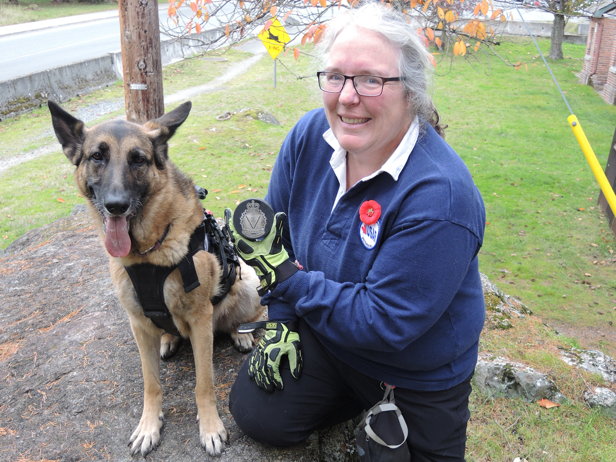 Nine-year-old German Shepard Miss Moxxii and her handler Angela Lavergne show off the special commemorative puck they will use in the ceremonial opening puck drop for the Victoria Royals Defence Appreciation Night at the Save On Foods Memorial Centre on Nov. 15. Photo by Peter Mallett/Lookout