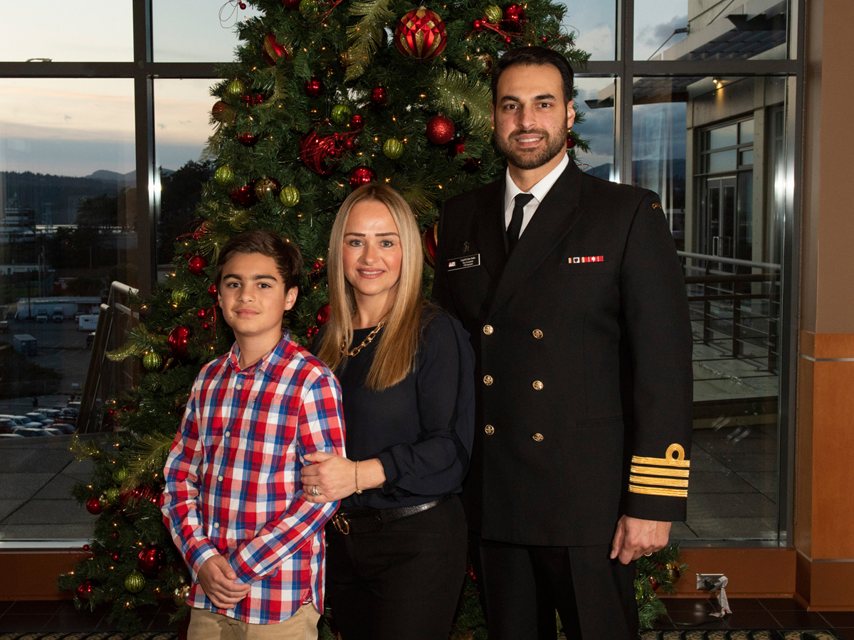 Captain (Navy) Sam Sader, Base Commander, and his wife Irena Sader, and son, Armand Sader, pose for a family photo at the Wardroom. Photo by Master Corporal André Maillet, MARPAC Imaging