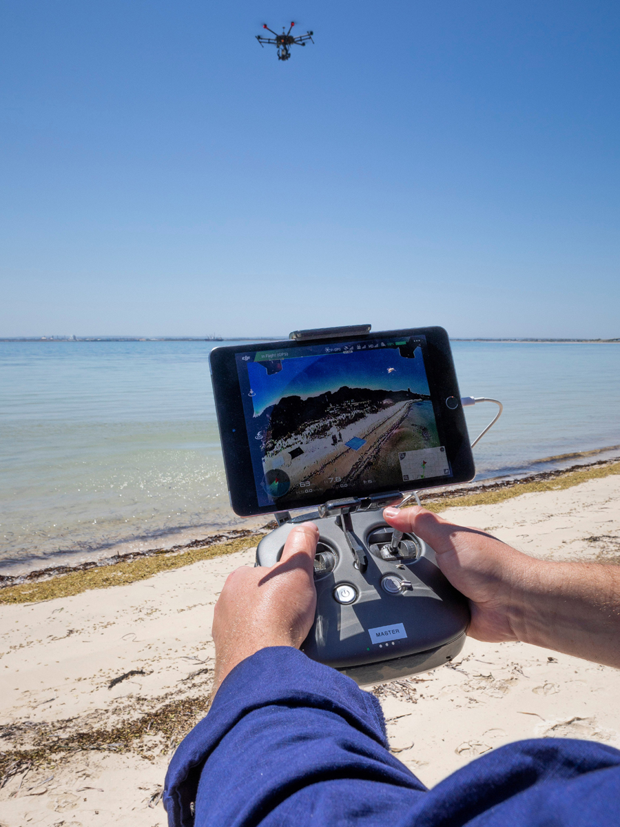 Dr. Brad Evans, Defence Science and Technology Group Leader, Littoral Sensing and Processing Group, flies a drone to conduct mine detection. Photo by LSIS Kylie Jagiello, Navy Imagery Unit - West