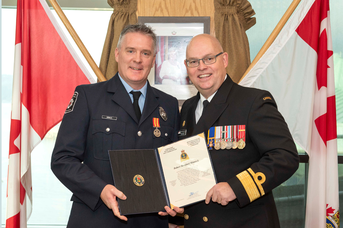 Robert Minnick receives a Commander Royal Canadian Navy Commendation presented by Commander Maritime Forces Pacific Rear-Admiral Bob Auchterlonie. The citation reads: On 28 November 2018, Mister Minnick was on the beach on the island of Maui, Hawaii when he noticed a person being dragged to shore and moved to assist. After bringing the unconscious man to shore, he took control of the scene and began administering first aid and cardiopulmonary resuscitation until first responders arrived. These actions saved the life of the drowning victim. He brought great credit to himself and to the Royal Canadian Navy. Photo by LS Valerie LeClair, MARPAC Imaging Services