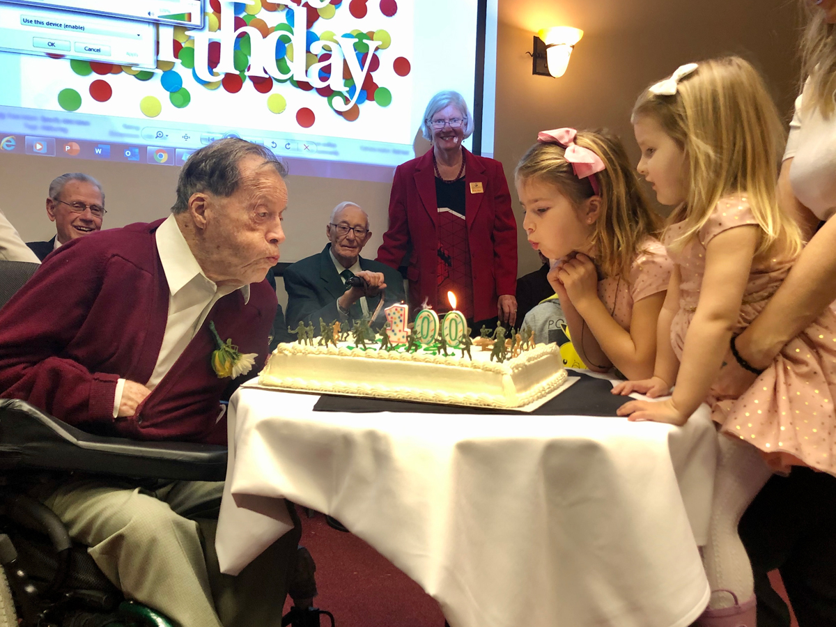 Major (Ret’d) Murray Edwards blows out the candles on his birthday cake. Edwards, a veteran of the Second World War and Korea recently celebrated his 100th birthday with a large group of family and friends by his side. Photo credit: Brian Owens