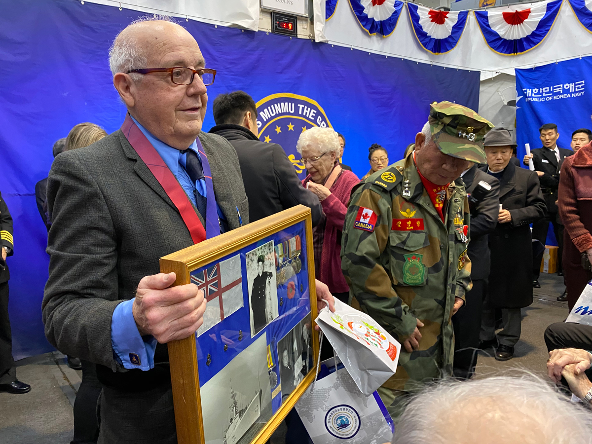 LS (Ret’d) Roderick Finley displays a photographic collection featuring his late friend and former shipmate CPO2 Fred Watson. Finley was aboard South Korean vessel ROKS Munmu the Great during a Port visit to Esquimalt in December. He accepted a South Korean Ambassador for Peace medal on behalf of Watson during a ceremony that also honoured nine other Korean War veterans.