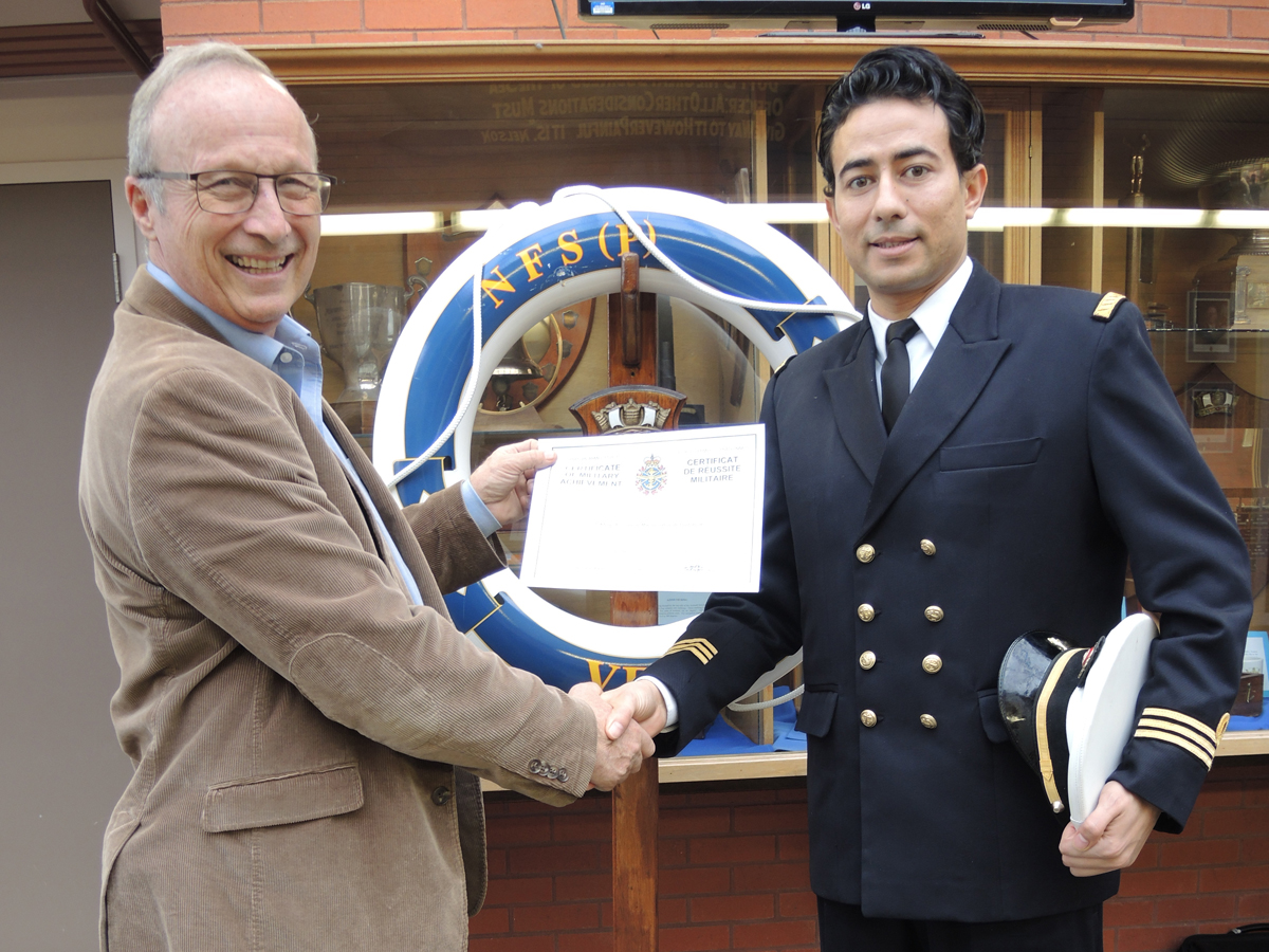 Captain (N) (Ret’d) Kevin Greenwood, Naval Instructor at Naval Training Development Centre (Pacific) presents Tunisian naval officer Lt(N) Khayri Bouzaiene with his Command Development Course certificate at the Collier Building at Work Point. Photo by Peter Mallett, Lookout Newspaper