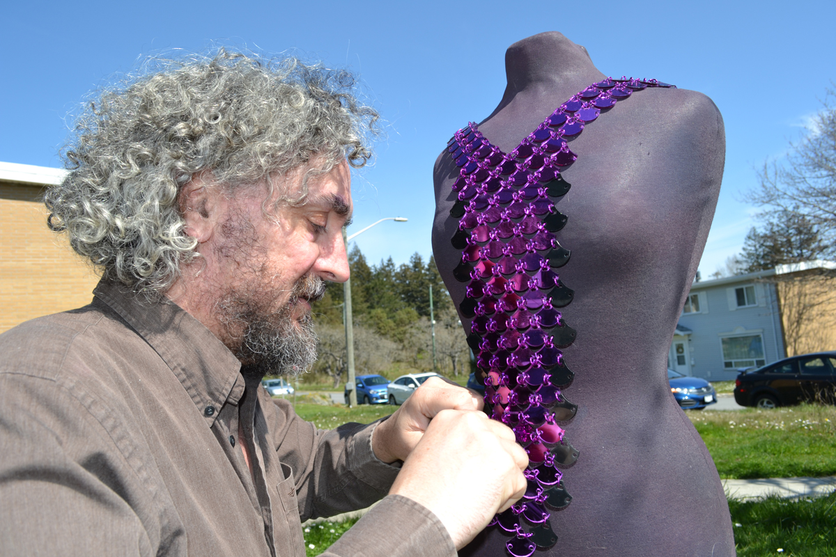 Mead Simon adjusts one of the creations from Mead Simon Chainmail Designs. Simon is a chain-mail artist, jeweler, and fashion designer.  Photo credit Shoghi Simon
