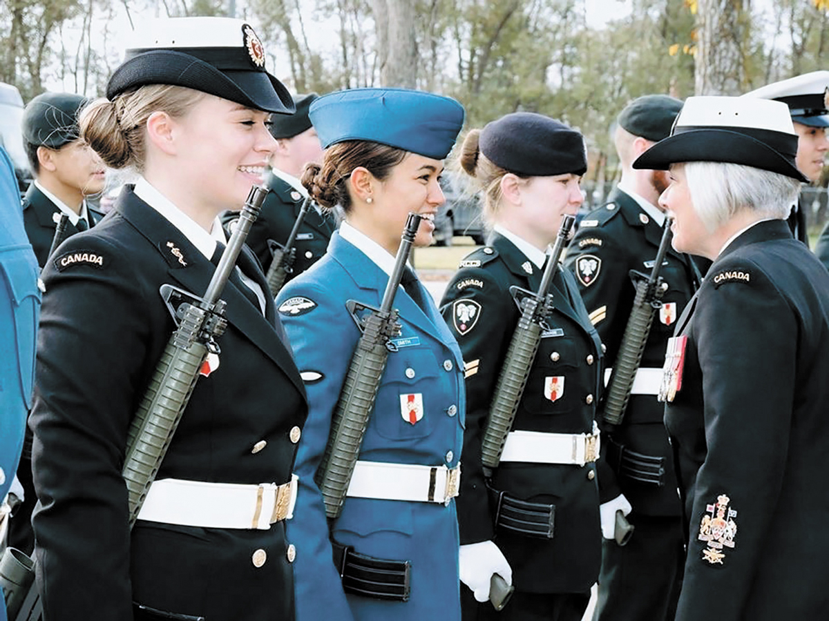 CPO1 Lucie Simpson talks to three women on parade.