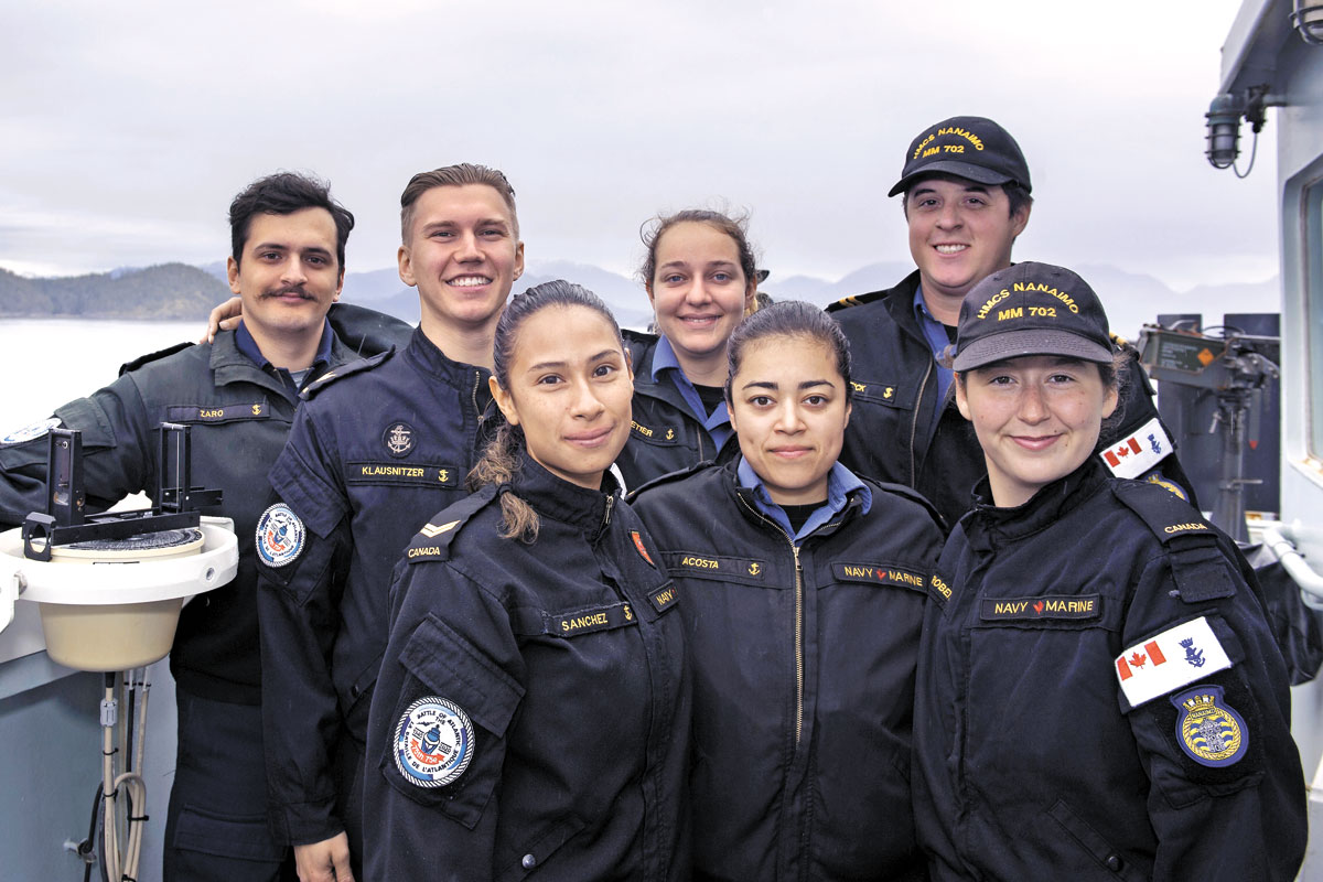 Members of the Sunday service group pose on the bridge wing of HMCS Nanaimo as the ship transits off the coast of Vancouver Island. Left to Right: LS Ramsin Zaro, LS Randy Klausnitzer, LS Kathy Sanchez, SLt Jessica Pelletier, OS Amy Acosta, Lt(N) Mark Herrick, and OS Jesse Roberts.