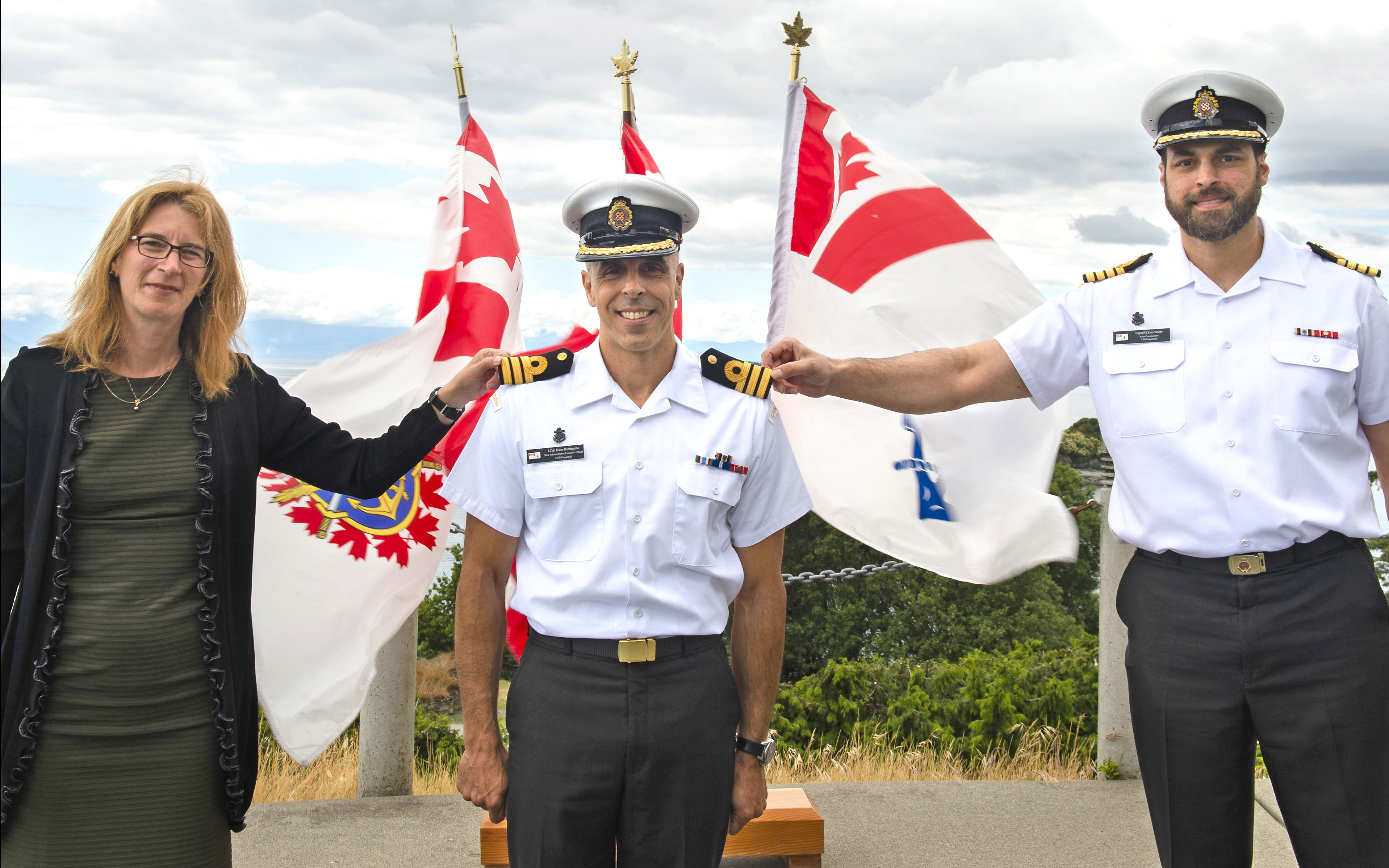 Commander Jason Barbagallo (middle), Base Administration Executive Officer, with his wife Chantal, is promoted to his current rank by Capt (Navy) Sam Sader, Base Commander, on June 16, 2020. Photos by LS Kendric C.W. Grasby, MARPAC Imaging Services