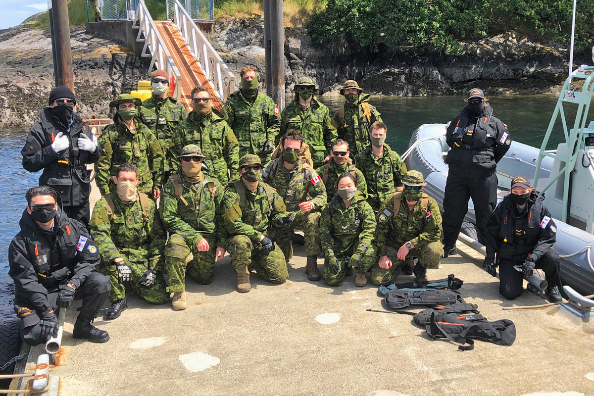Mission Complete: Army and Navy Reservists line the jetty at Albert Head following the at-sea move from HMCS Malahat in downtown Victoria to the training area during Exercise Strong Mariner May 22. Photo by Capt Jeff Manney, 39 CBG Public Affairs