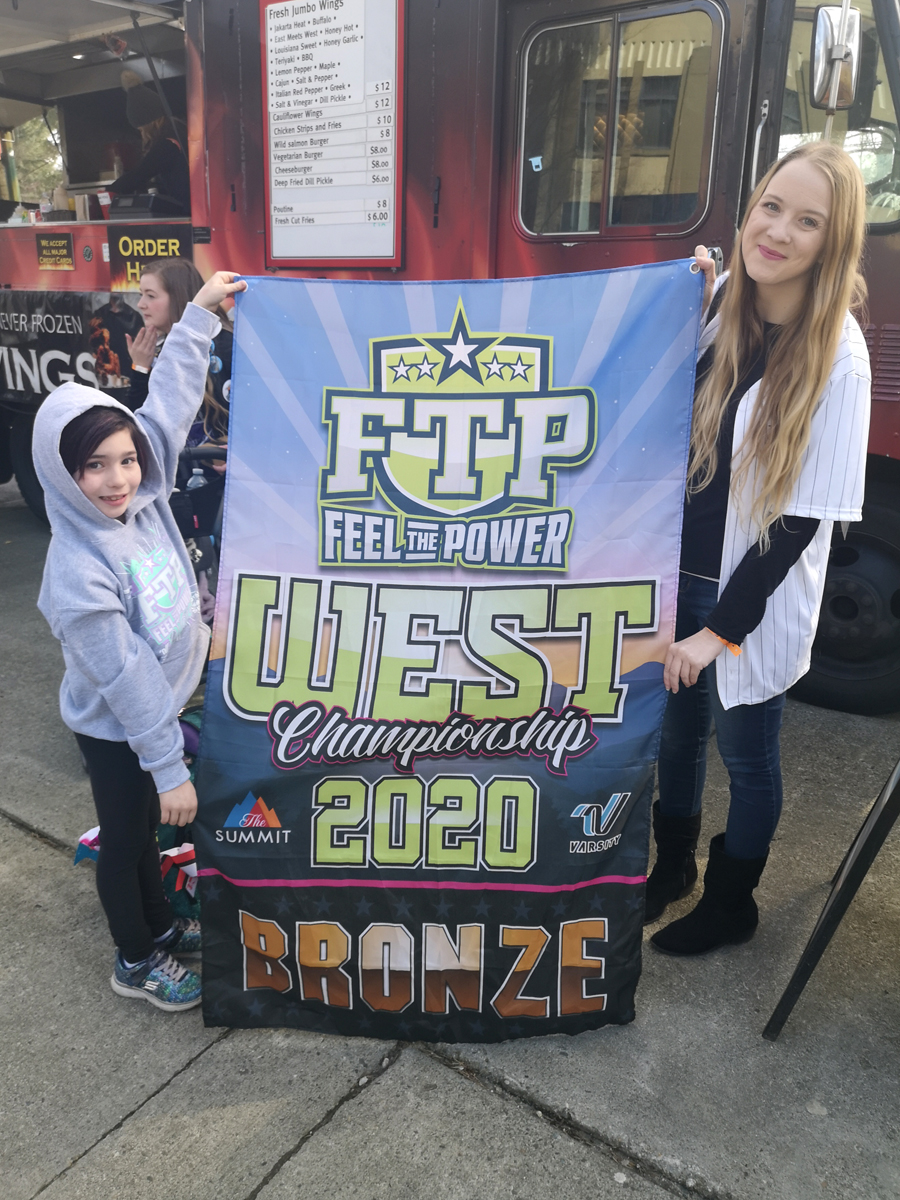 Cheerleader Jayna Flammand (left) and Pacific Cheer Empire owner and head coach Shannon Samson display Jayna’s bronze medal banner. Flammand is the eight-year-old daughter of Cpl Kevin Flammand. She won the banner for her individual performance at the Feel The Power West Coast Championship in Vancouver, March 7, 2020. The Colwood-based sports club has several military family members and is currently looking to grow its membership. Photo by Sylvie Blais, Pacific Cheer Empire