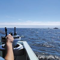 A/SLt Anjad Aliak, a naval reservist with HMCS Donnaconna, gets a bearing of other ships while aboard Patrol Craft Training Vessel Cougar on July 22. A/SLt Aliak was conducting Officer of the Watch manoeuvers on the Victoria waterfront as part of his Naval Warfare Officer Phase 3 Training. Photo by Lt(N) Tom Eagle, PCTU.