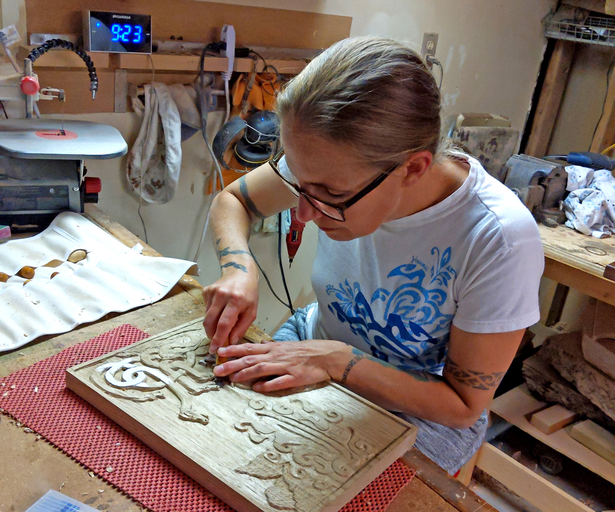 Lt(N) Gill Herringer puts the finishing touches on a carving created in her new workspace.