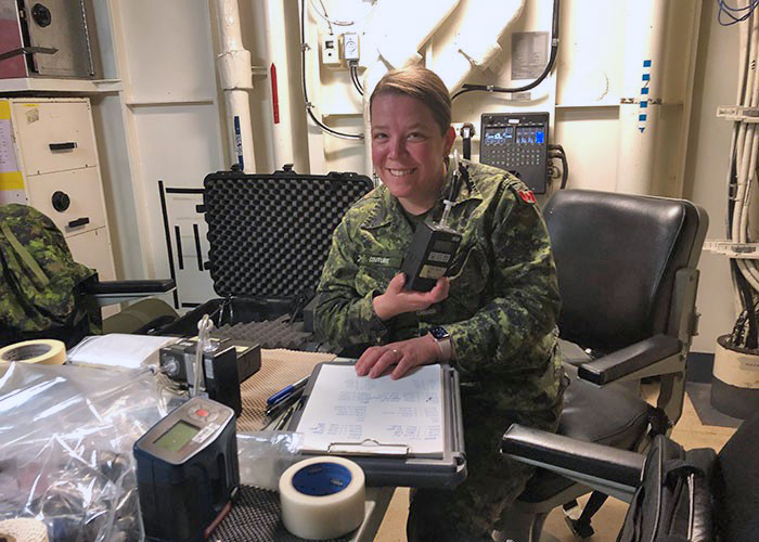 While deployed on a Royal Canadian Navy submarine, Warrant Officer Josée Couture, a Preventive Medicine Technician and member of the Deployed Health Hazard Assessment Team, prepares air sampling equipment to help ascertain air quality as part of an ongoing Canadian Forces Health Services occupational health study.