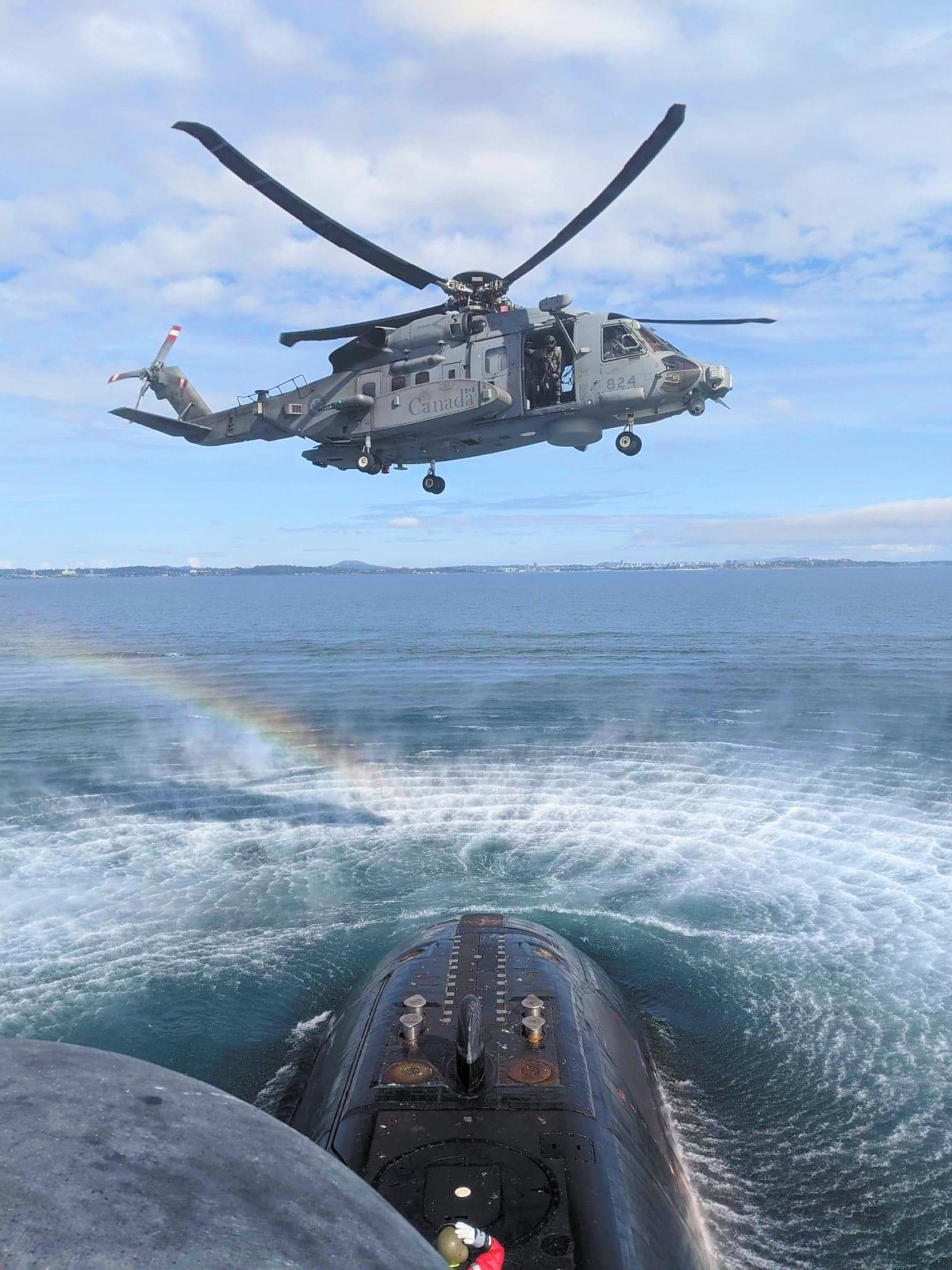A CH-148 Cyclone helicopter conducts a training exercise with HMCS Victoria on Sept. 22. The submarine commenced sea trials on Sept. 18, marking its first time at sea since February 2015. Photo by LCdr H.T. Nguyen-Huynh, Executive Officer, HMCS Victoria