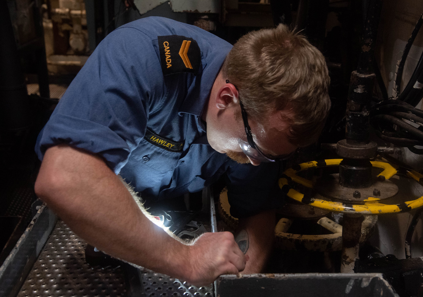 S1 Sheldon Hawley conducts maintenance on valves in the Forward Auxiliary Machine Room.