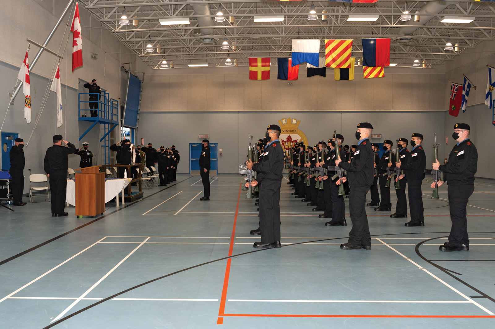 Graduates of Basic Military Qualification R0236E present arms during their Graduation Ceremony at the Nixon Gym in Work Point on Oct. 23. Photo by S1 Sisi Xu, MARPAC Imaging Services