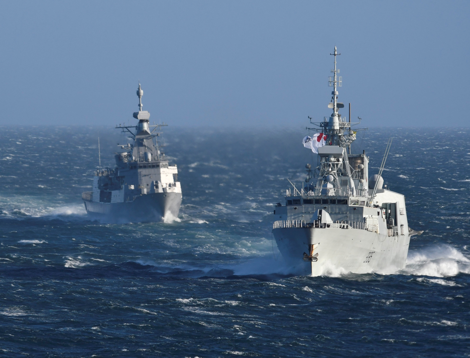 HMCS Calgary (left) and HMNZS Te Kaha (right) conduct a sail past Esquimalt Lagoon as Te Kaha heads back to New Zealand after spending 18 months in Esquimalt completing an extensive upgrade and refit program.