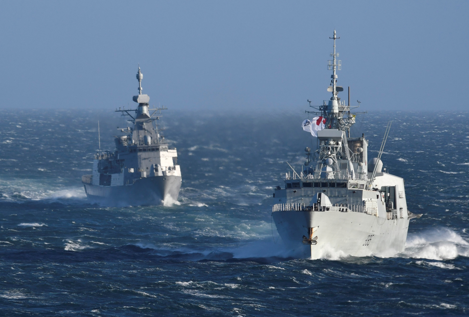 HMNZS Te Kaha (left) and HMCS Calgary (right) conduct a sail past Esquimalt Lagoon as Te Kaha heads back to New Zealand after spending 18 months in Esquimalt completing an extensive upgrade and refit program.