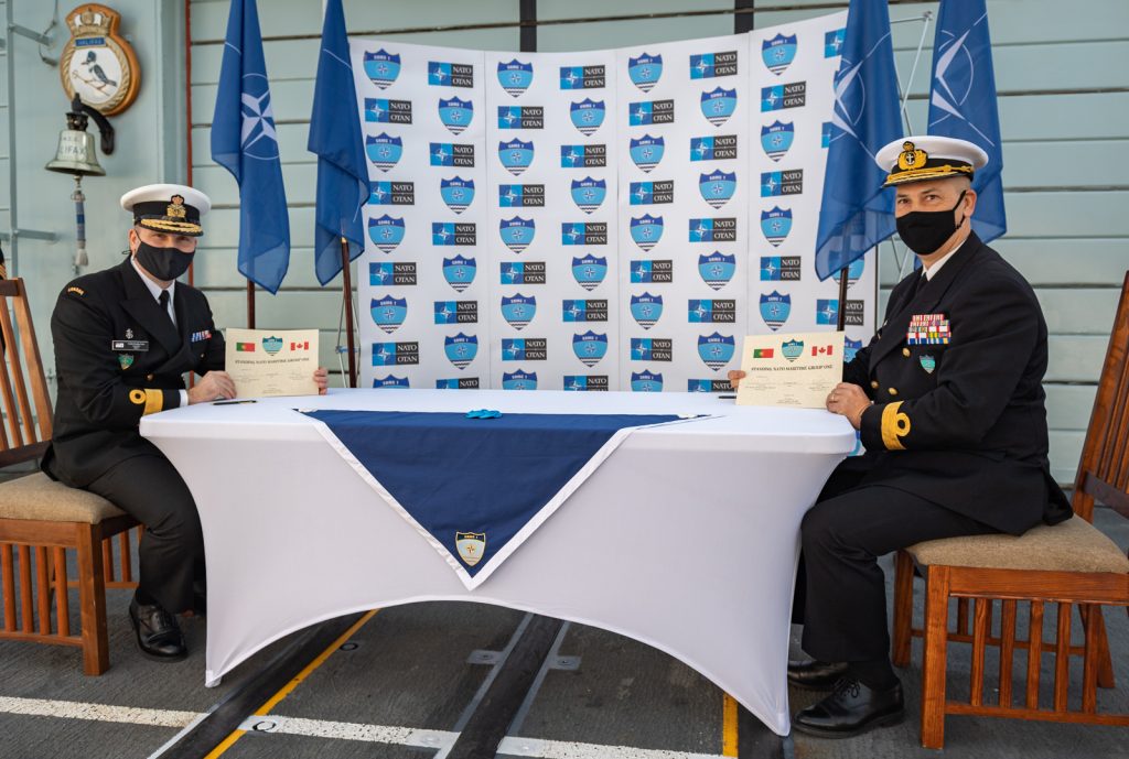 Commodore Bradley Peats of the Royal Canadian Navy and Commodore José António Mirones of the Portuguese Navy sign change of command certificates during a Standing NATO Maritime Group One change of command ceremony held on board HMCS Halifax in Lisbon, Portugal, on Jan. 18. Photo by Sailor First Class Bryan Underwood, Imagery Technician