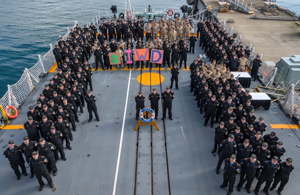 Members of HMCS Calgary stand together in support of International Women’s Day Feb. 27 on the flight deck. Photo by Cpl Lynette Ai Dang, CAF Imagery Technician