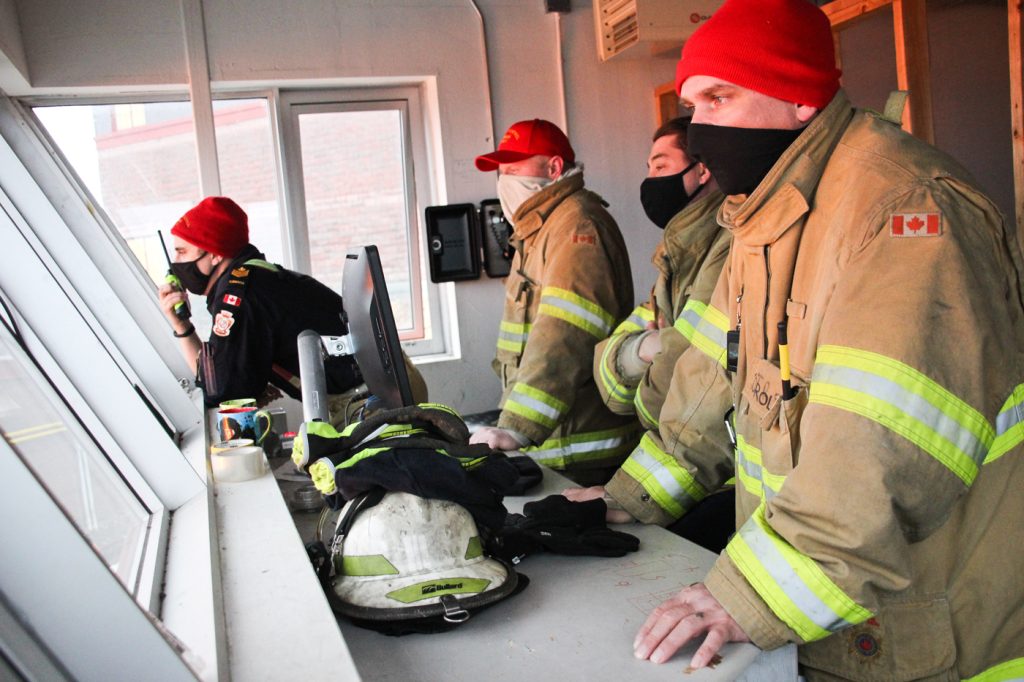 Naval Fleet School (Atlantic) staff look on from the control tower as their colleagues exercise the new helicopter simulator. Photo by Ryan Melanson, Trident Newspaper