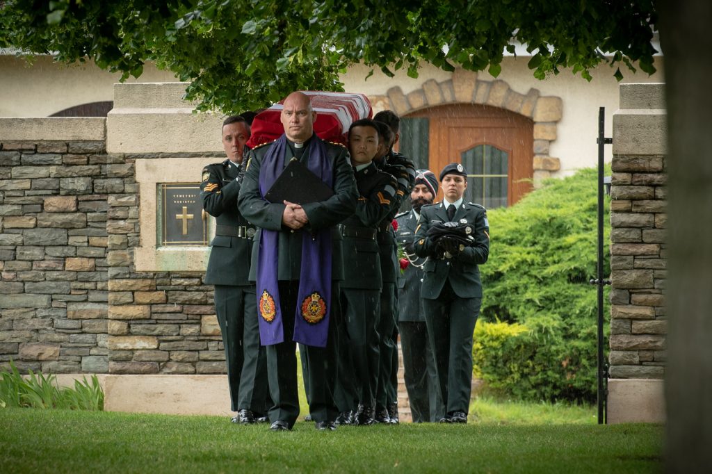 Captain Sye VanMaanen, Padre, leads the burial party from The British Columbia Regiment on June 12, 2019, during the burial ceremony of First World War fallen soldier, Private George Alfred Newburn at the Commonwealth War Graves Commission’s Loos British Cemetery outside Loos-en-Gohelle, France. Photo by MCpl PJ Letourneau, Canadian Forces Combat Camera