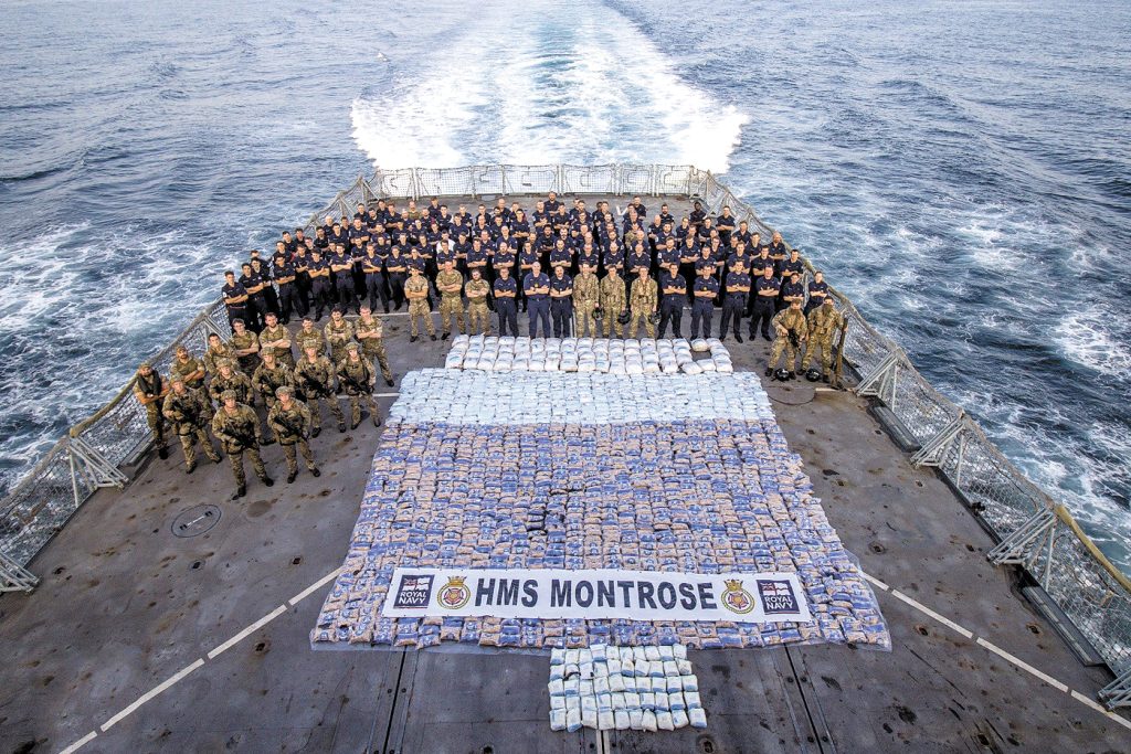 Royal Navy and Royal Marines from HMS Montrose stand with more than 2,800 kilograms of narcotics seized from a vessel in the Arabian Sea on March 12. Photo: AET Josh Edwards RN