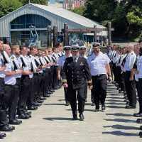 Sailors lined the floats at the Seamanship Training Centre for departing officer LCdr Mike Erwin. Following that, they removed their caps and gave three cheers as the Whaler, staffed by senior staff of Naval Fleet School Pacifc, pulled away to row him ashore.
