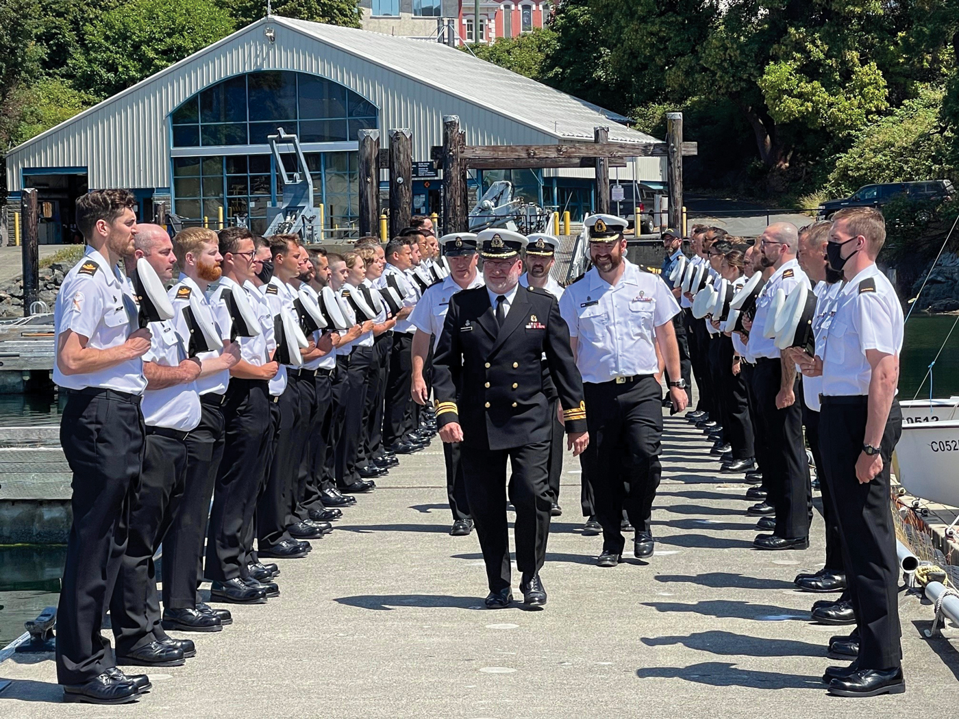 Sailors lined the floats at the Seamanship Training Centre for departing officer LCdr Mike Erwin. Following that, they removed their caps and gave three cheers as the Whaler, staffed by senior staff of Naval Fleet School Pacifc, pulled away to row him ashore.
