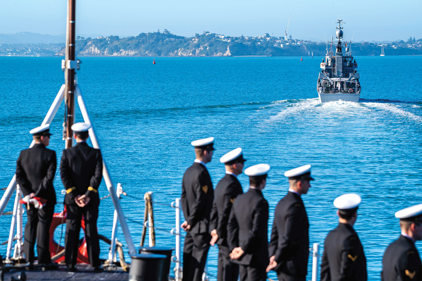 Royal Canadian Navy sailors aboard HMCS Calgary stand at ease on the forecastle as the ship is escorted into Auckland by HMNZS Taupo. Photos by Corporal Lynette Ai Dang, Canadian Armed Forces Photo