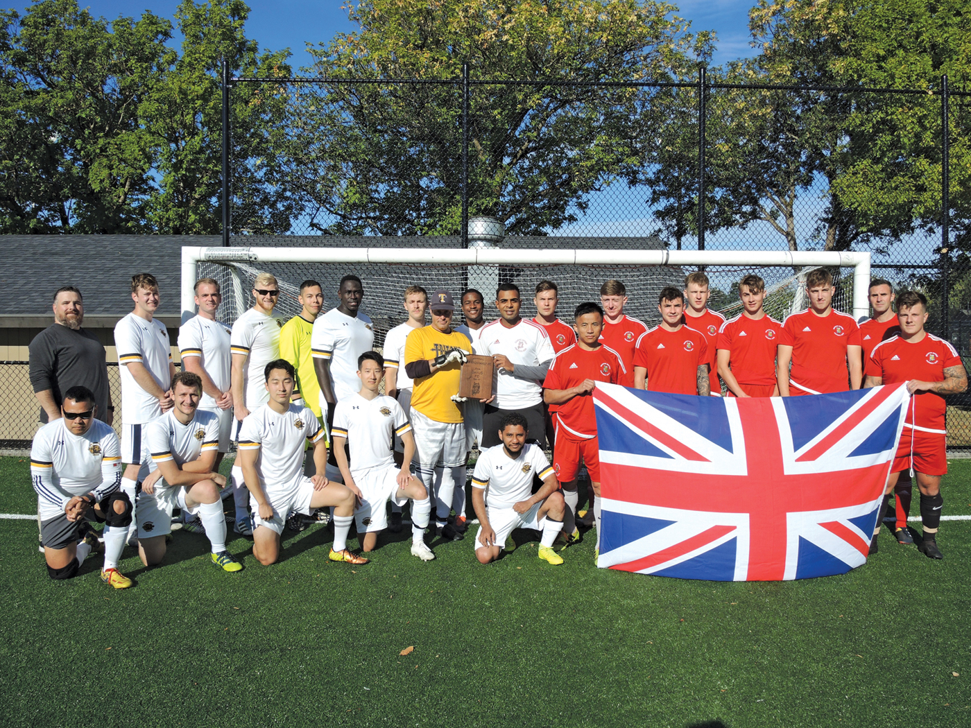 The men’s Tritons and British Army Training Unit Suffield soccer teams after a friendly soccer game.
