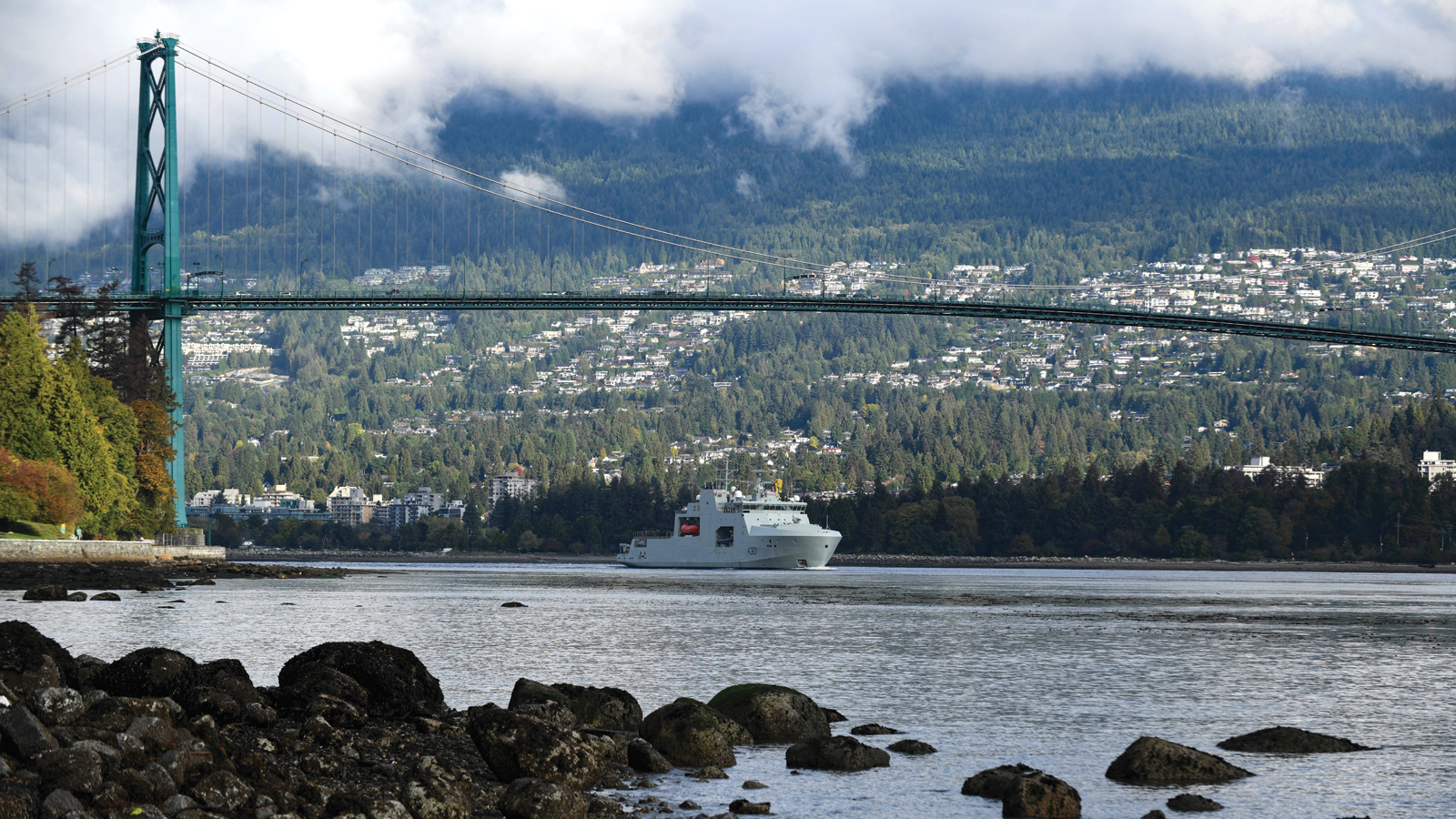HMCS Harry DeWolf traverses under the Lions Gate Bridge in Vancouver, British Columbia for the first time. Photo by MCpl Nathan Spence, MARPAC Imaging Services