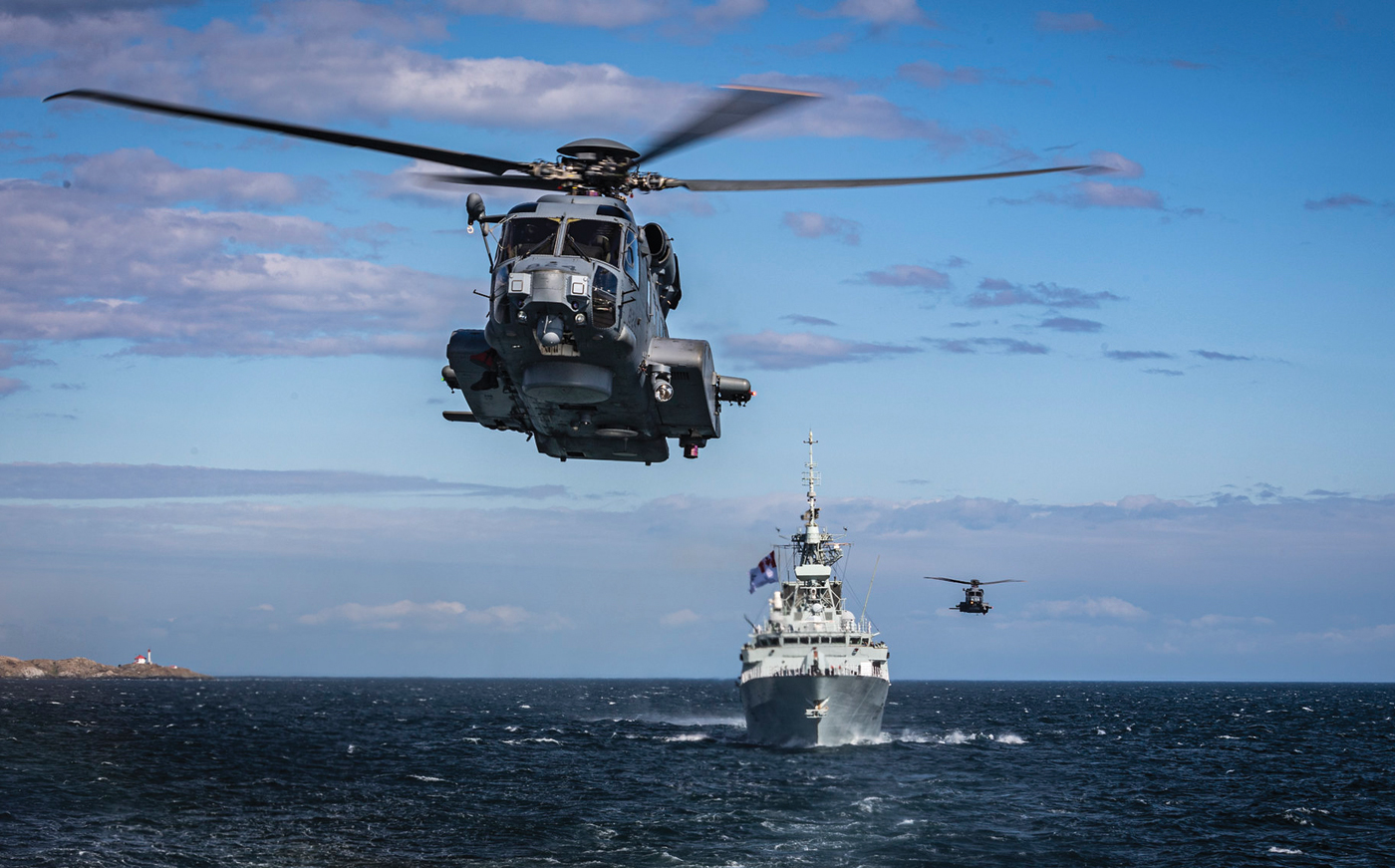The CH-148 Cyclone helicopters (seen here accompanying HMCS Winnipeg and HMCS Regina) are the RCNs main ship-borne maritime helicopter. Photo by MS Dan Bard, Canadian Forces Combat Camera
