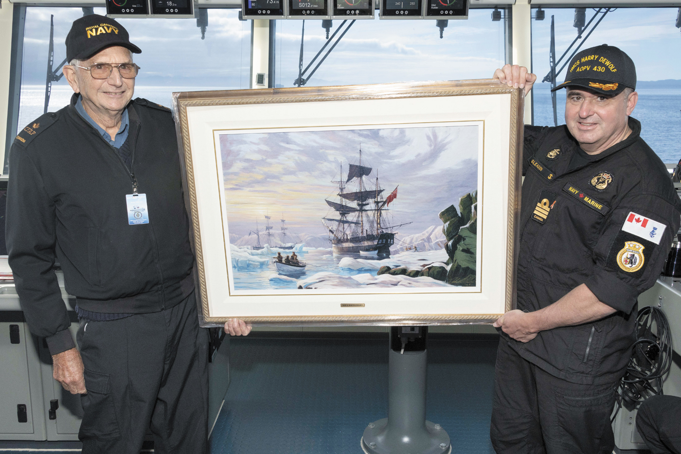 Artist John Horton presents his painting of HMS Erebus to the Commander of HMCS DeWolf, Cdr Cory Gleason. Photo by Corporal Simon Arcand, Canadian Armed Forces Imagery Technician