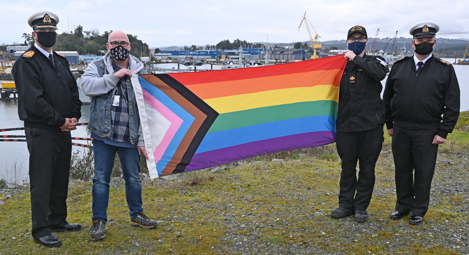 Pictured above: Captain (Navy) Martin Coates, champion of the Defence Team Pride Advisory Organization (DTPAO); Steve Cleugh, Civilian Chair of the DTPAO; Master Sailor Erin Rautenstrauch, Military Chair of the DTPAO; and Chief Petty Officer First Class Al Darragh, Base Chief, hold the Progress Pride Flag that will be raised at CFB Esquimalt for the first time on Saturday, Nov. 20.