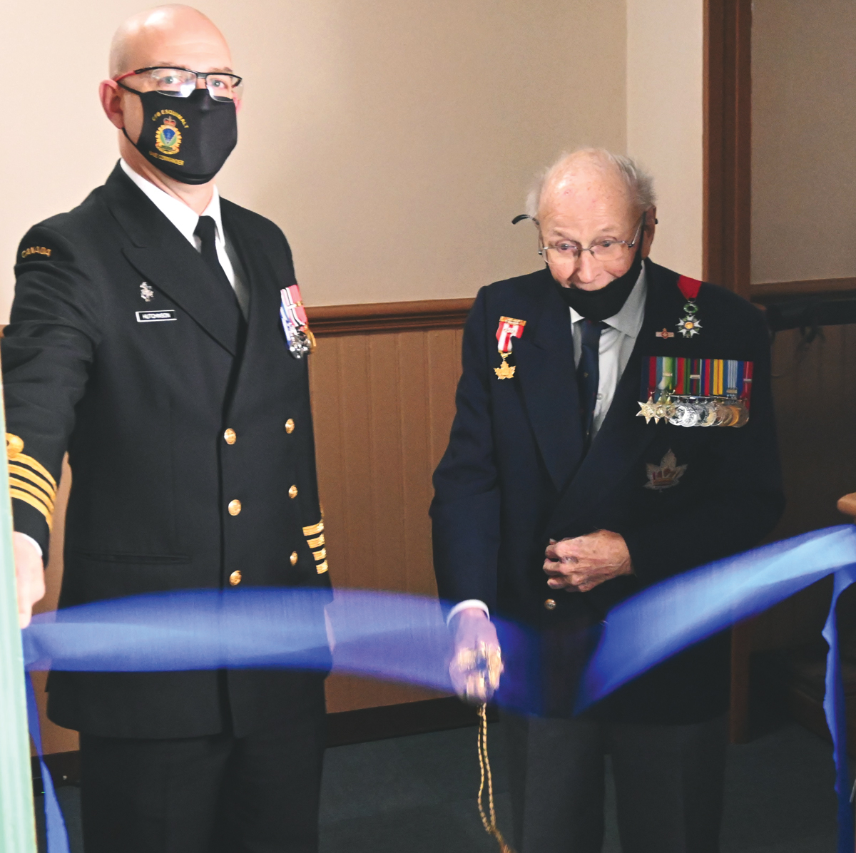 Capt(N) Jeff Hutchinson, Base Commander, and 101-year-old Peter Chance cut the ribbon to officially open the Peter Goodwin Chance Battle of the Atlantic exhibit at the base museum. Photo by Rodney Venis, Base Public Affairs