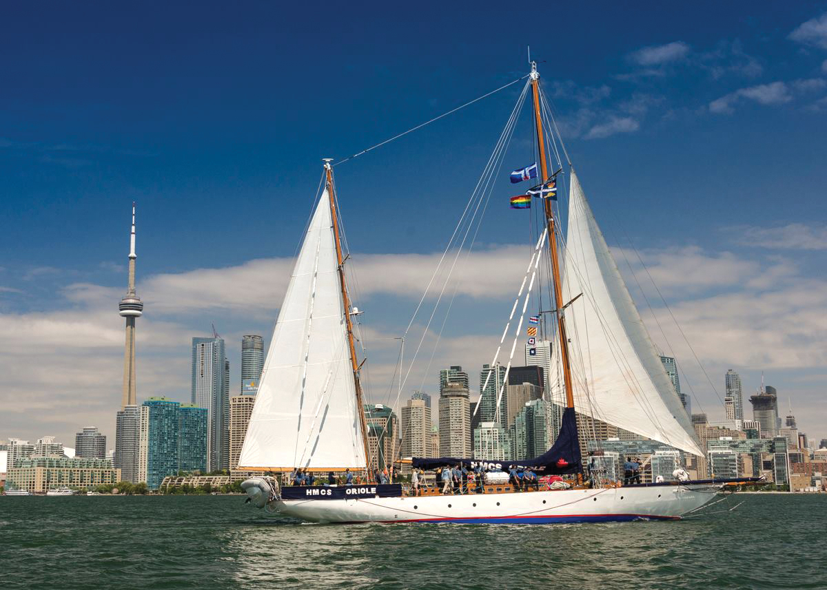 HMCS Oriole with a crew of cadets sails past Toronto’s CN Tower in 2018. 