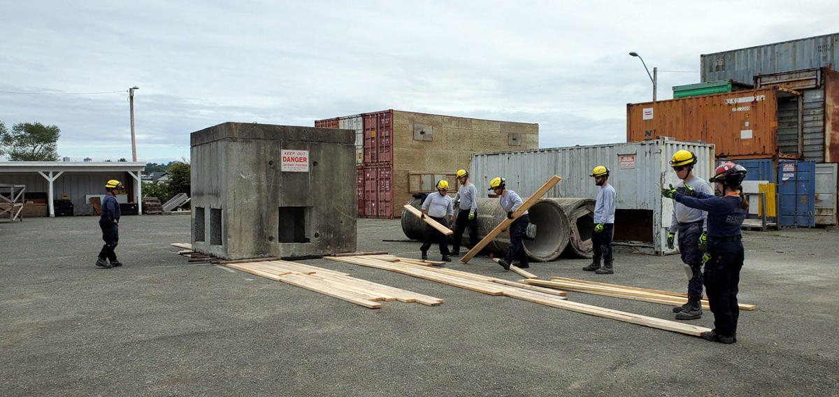USAR team members work together to conduct a 30-ton heavy lift and move exercise.