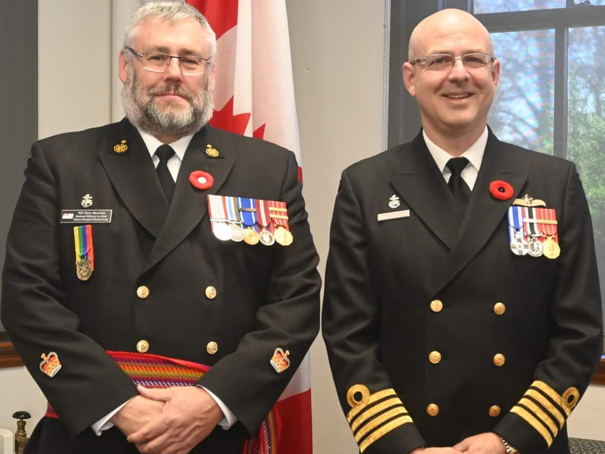 Base Commander Capt(N) J. Jeffrey Hutchinson (right) presents Petty Officer First Class (PO1) Steve Morrison