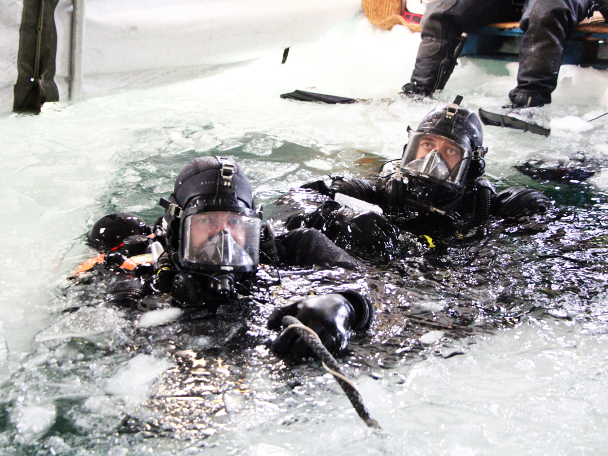 Two members of the ICEDIVEX23 team return to the surface of Sheridan Lake after a dive. 
Photo: Patrick Davies,100 Mile Free Press 