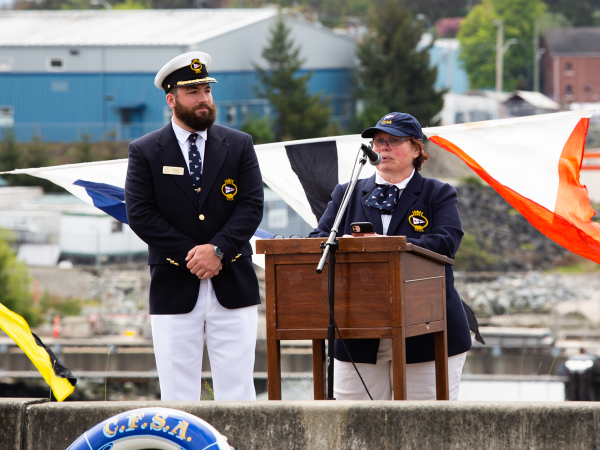 Leslie Basham, CFSA Fleet Captain, makes opening remarks with Ben Sproule, the club’s Commodore, during Opening Day celebrations.