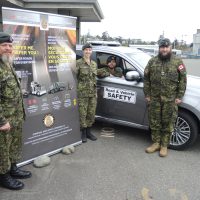 (Left) Master Warrant Officer Renaud Michel, Lieutenant Anabelle St-Martin, Second Lieutenant Naman Sharma and Corporal Trevor Leslie of TEME display this year's Department of National Defence National Road Safety Week promotional poster at their Work Point headquarters, May 4. This year's campaign titled "Safer Me, Safer You" runs May 15 to 21 Photo: Peter Mallett/Lookout Newspaper