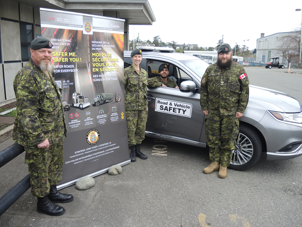 (Left) Master Warrant Officer Renaud Michel, Lieutenant Anabelle St-Martin, Second Lieutenant Naman Sharma and Corporal Trevor Leslie of TEME display this year's Department of National Defence National Road Safety Week promotional poster at their Work Point headquarters, May 4. This year's campaign titled "Safer Me, Safer You" runs May 15 to 21 Photo: Peter Mallett/Lookout Newspaper 