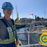 Brad Pendlington stands in the sun outside his current Work Centre's Shop 144 Electrical at FMF Cape Breton.