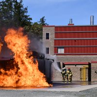 Naval Fleet School (Pacific) trains for helicopter crash rescue with Damage Control Division.