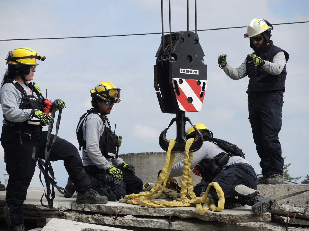 Members of the MUSAR team work to clear debris from the top of a pile of concrete rubble at their training site in Work Point, May 31. Photo: Peter Mallett/Lookout